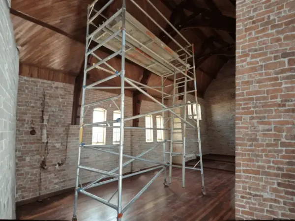 Scaffold tower set up inside a heritage brick building with exposed timber trusses, for a Bunbury interior job