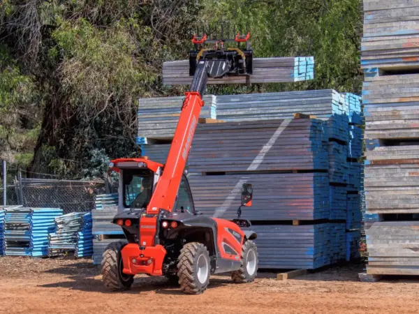 Compact telehandler lifting stacked scaffold gear at a Bunbury job site