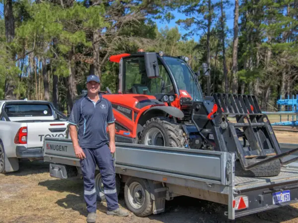 Bay Scaffold team member with the Manitou telehandler loaded on a trailer near Cowaramup