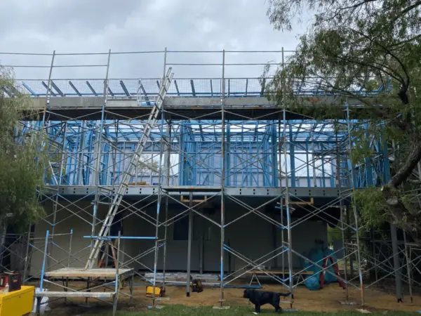 Steel-framed second storey addition wrapped in scaffold during a Dunsborough build