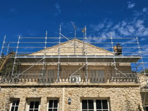 Roof-level scaffold platform on a heritage stone building during an Eagle Bay job