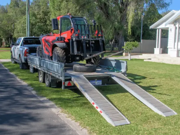 Bay Scaffold telehandler on a trailer with loading ramps down, ready for an Eagle Bay job