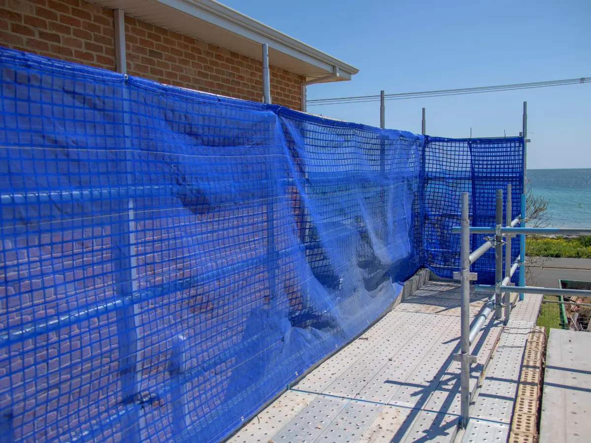 Heavy duty safety mesh fitted to scaffold on a construction site