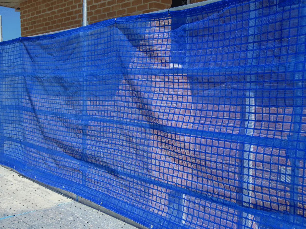 Shade cloth attached to temporary fencing on a building site