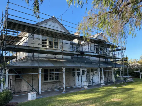 Federation-style homestead with a full roof scaffold wrap during a Margaret River restoration