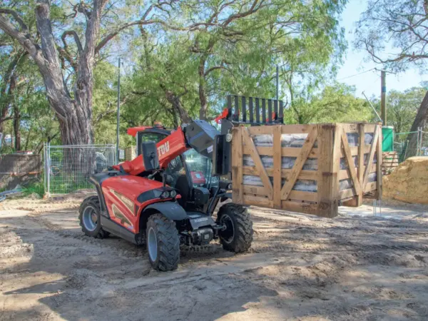 Bay Scaffold telehandler parked beside a timber crate stack at a Margaret River site