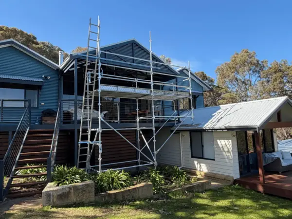 Scaffold on the gable end of a timber weatherboard holiday home in Yallingup