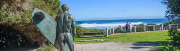 Bronze surfer statue overlooking the ocean at Yallingup